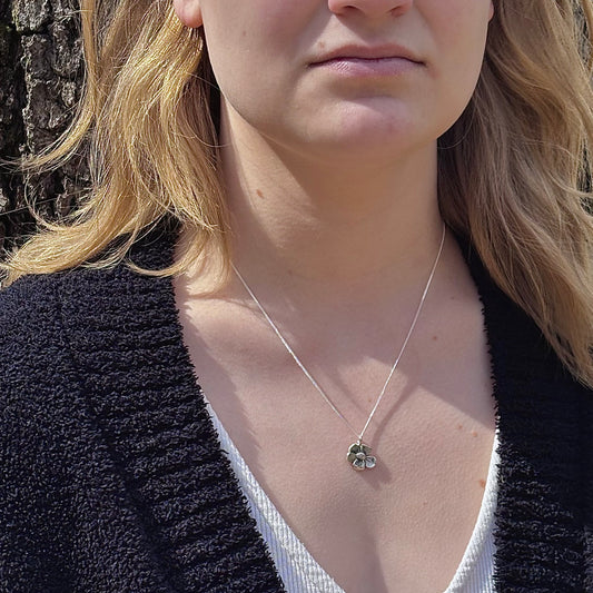Wild Bloom Small Pendant in sterling silver, handcrafted flower necklace, shown on model