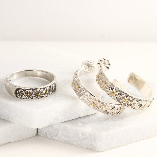 Wild Meadow Half Band and Hoop Earrings, hand carved flower jewelry shown on a white marble tile