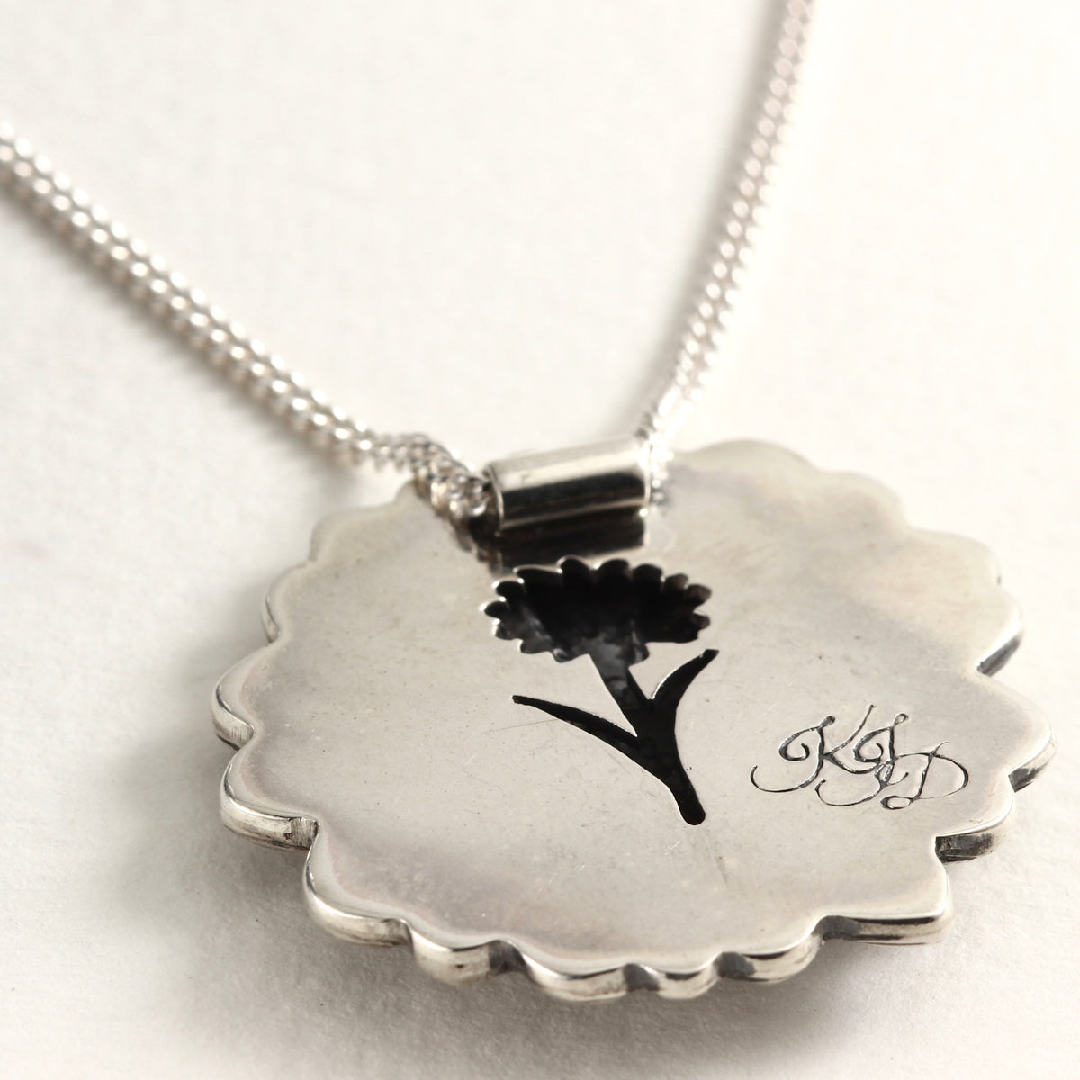 Back view of Wild Radiance Daisy Pendant in sterling silver, handcrafted flower necklace, on white background