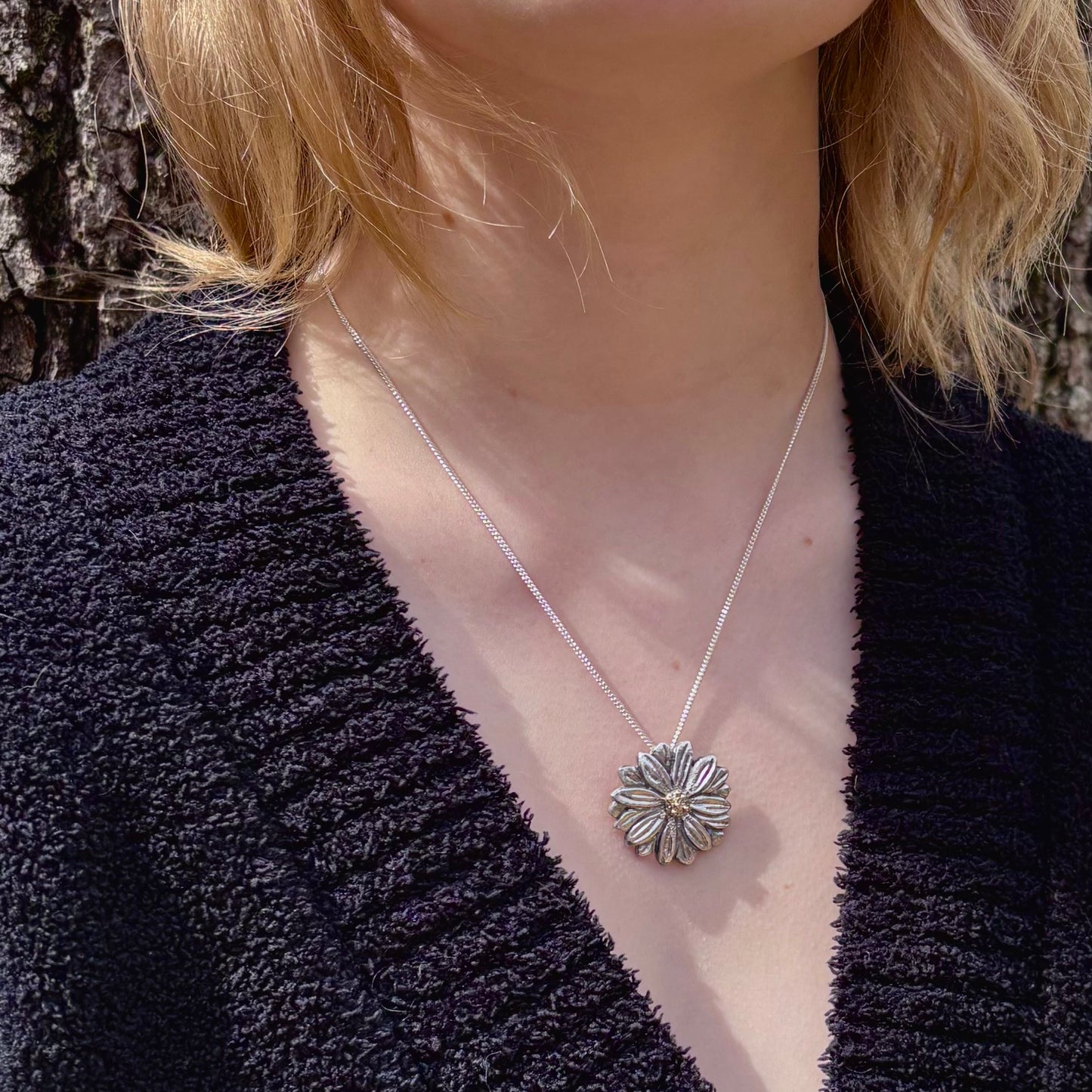 Wild Radiance Daisy Pendant with Gold Center in sterling silver, shown on a model