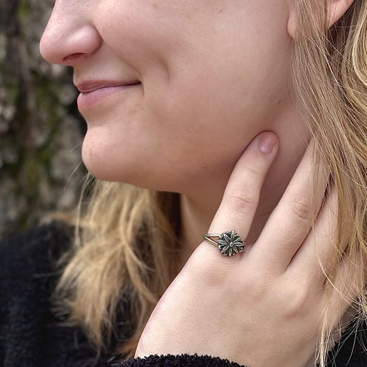 Wild Radiance Ring in sterling silver, a handcrafted flower ring, shown on a model