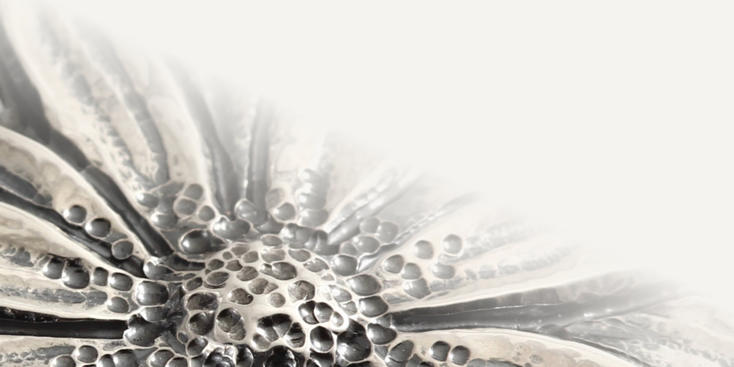 Banner image for the front page showing a close up of the daisy pendant