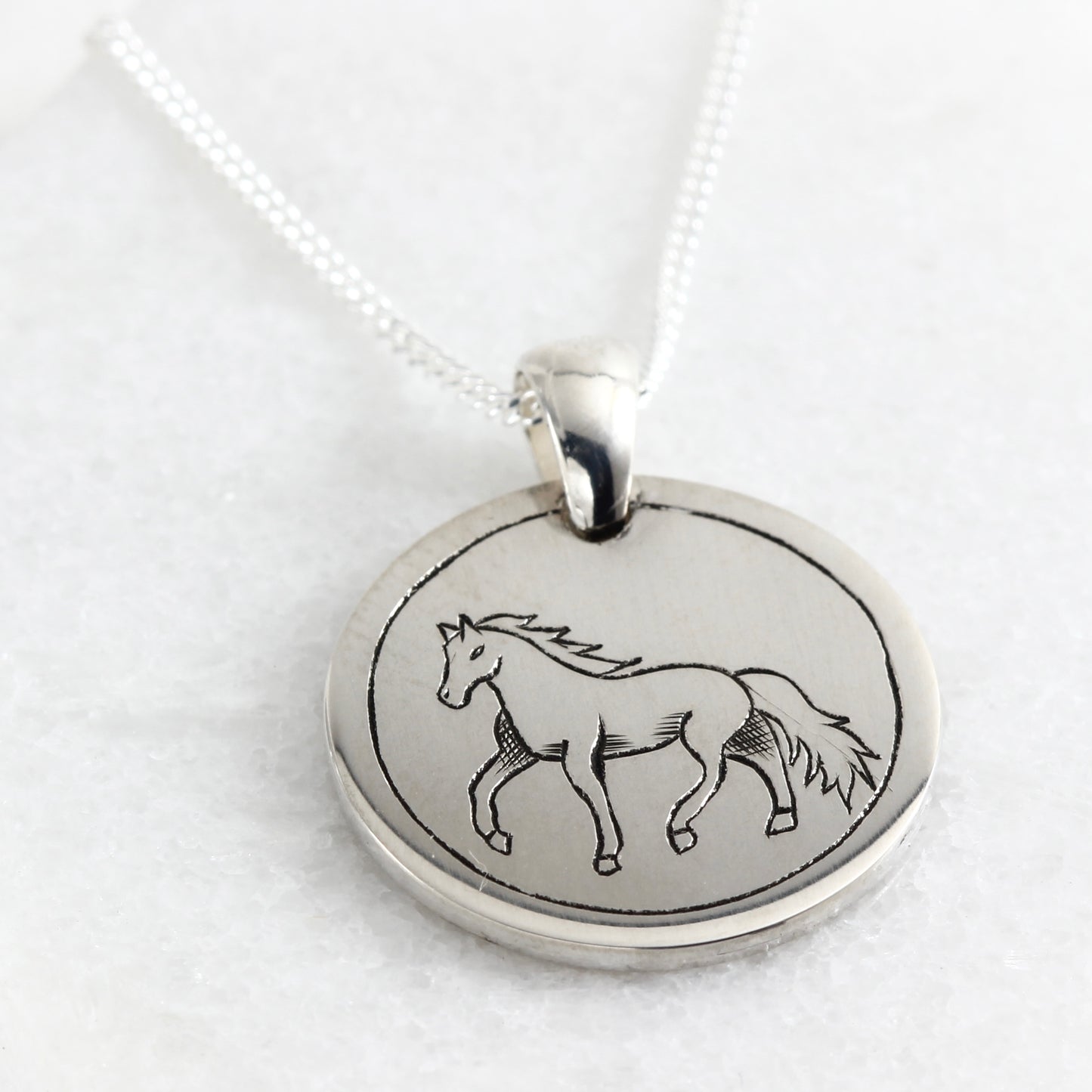 Small hand-engraved sterling silver pendant featuring a horse