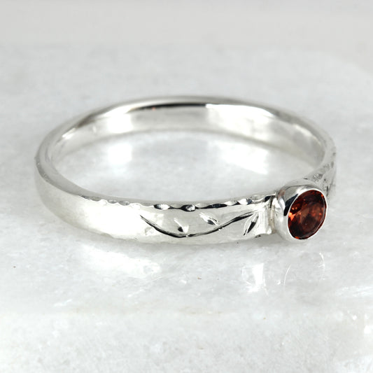 Side view of the Tendril Solitaire Ring in sterling silver, showing the gemstone and the hand engraved vine.