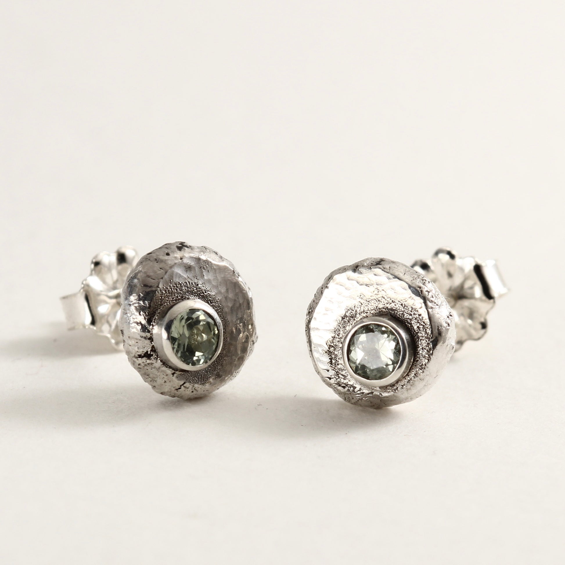 Wild Bud Stud Earrings in sterling silver with Montana sapphires, shown on a white background