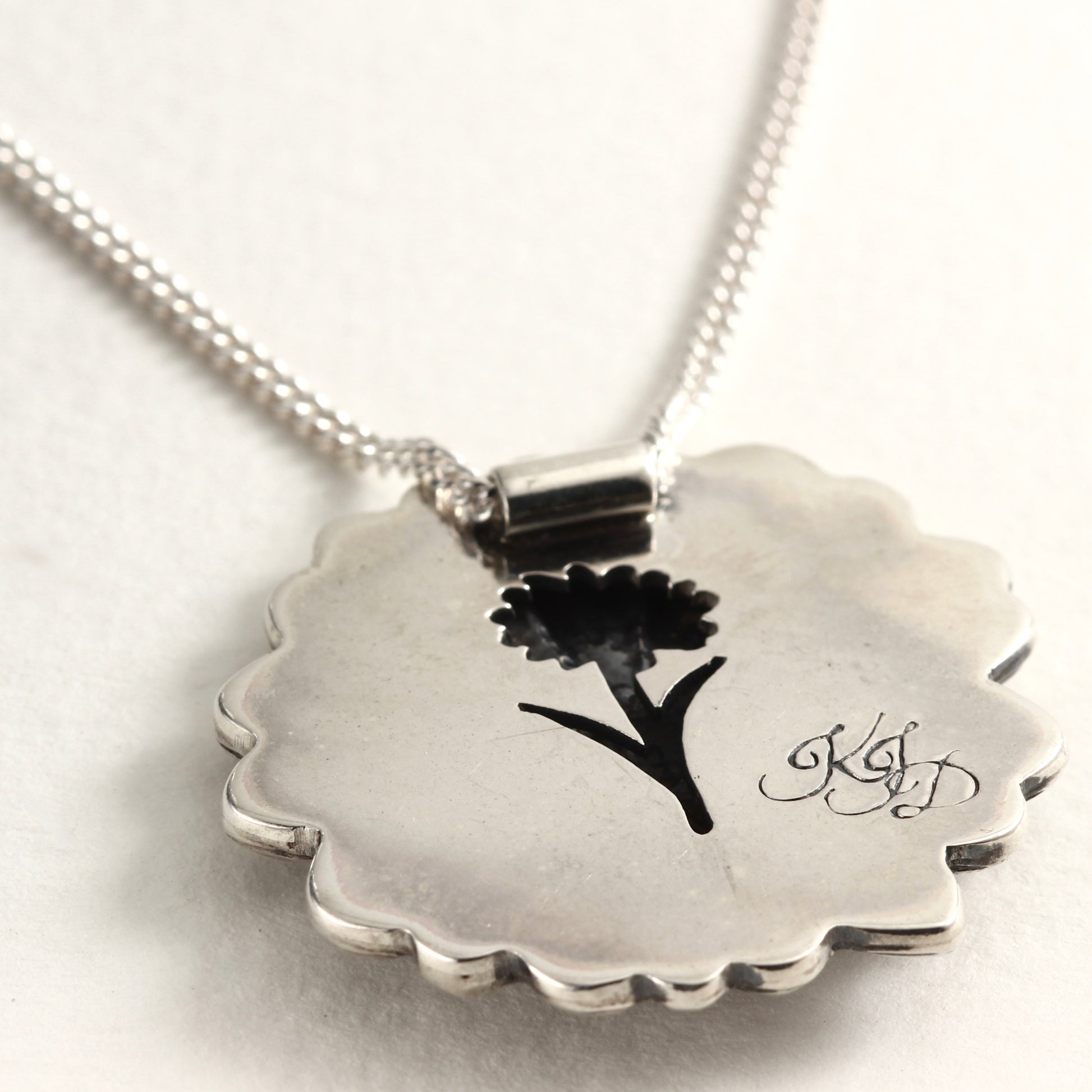 Back view of Wild Radiance Daisy Pendant in sterling silver, handcrafted flower necklace, on white background