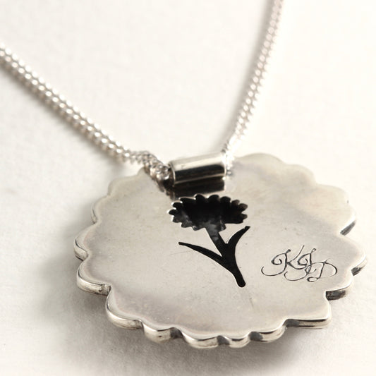 Back view of Wild Radiance Daisy Pendant in sterling silver, handcrafted flower necklace, on white background
