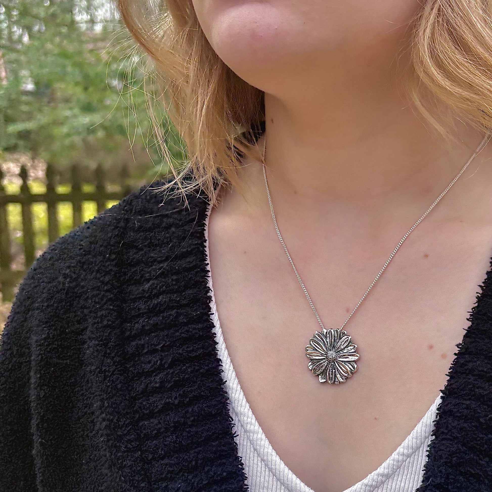 Wild Radiance Daisy Pendant in sterling silver, handcrafted flower necklace, shown on model