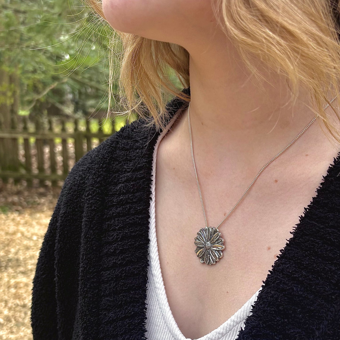 Wild Radiance Daisy Pendant in sterling silver, handcrafted flower necklace, shown on model
