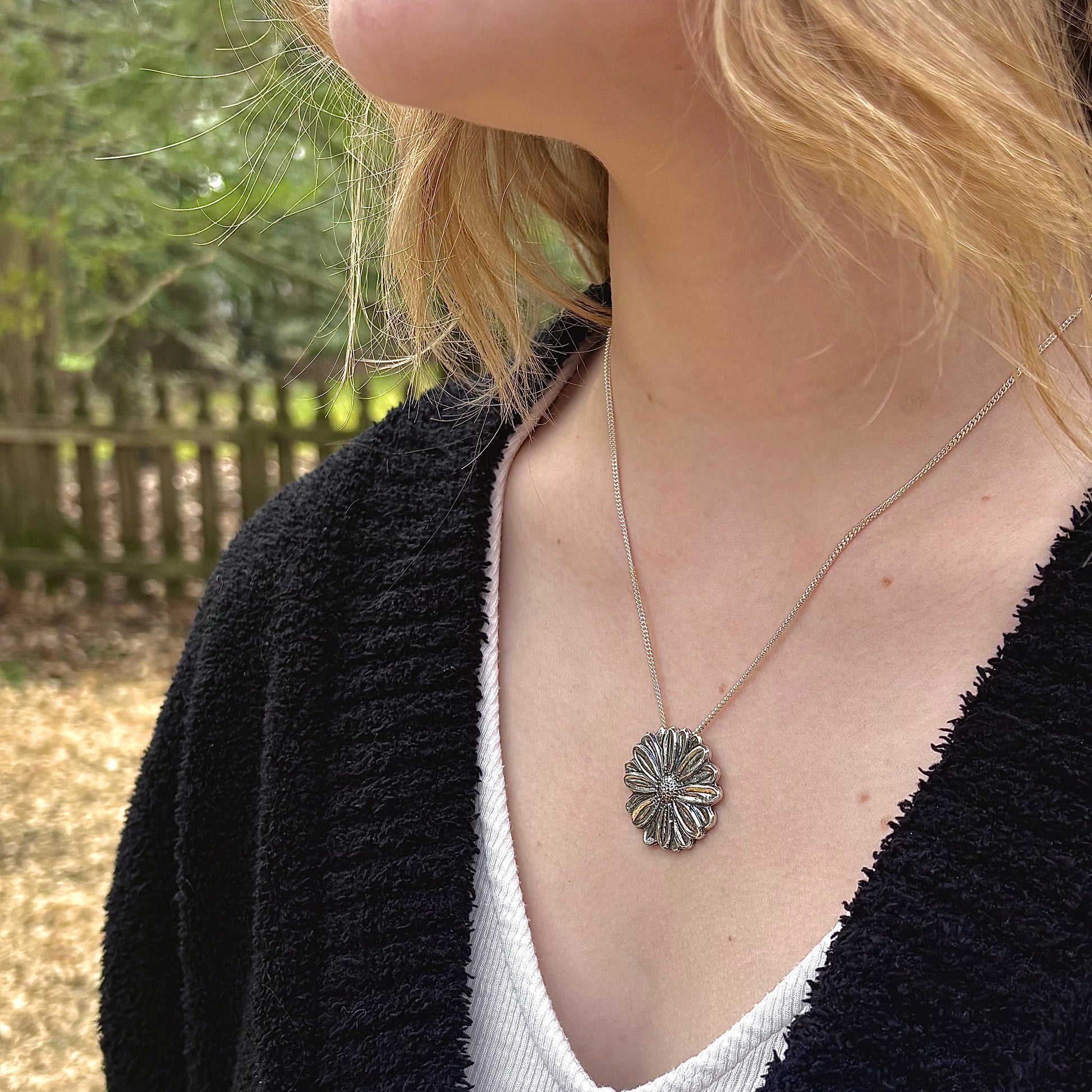 Wild Radiance Daisy Pendant in sterling silver, handcrafted flower necklace, shown on model