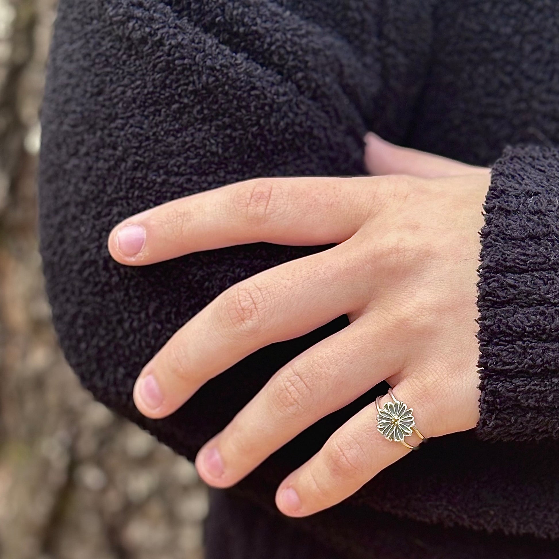 Wild Radiance Ring with Gold Center, a sterling silver handcrafted flower ring, shown on a model