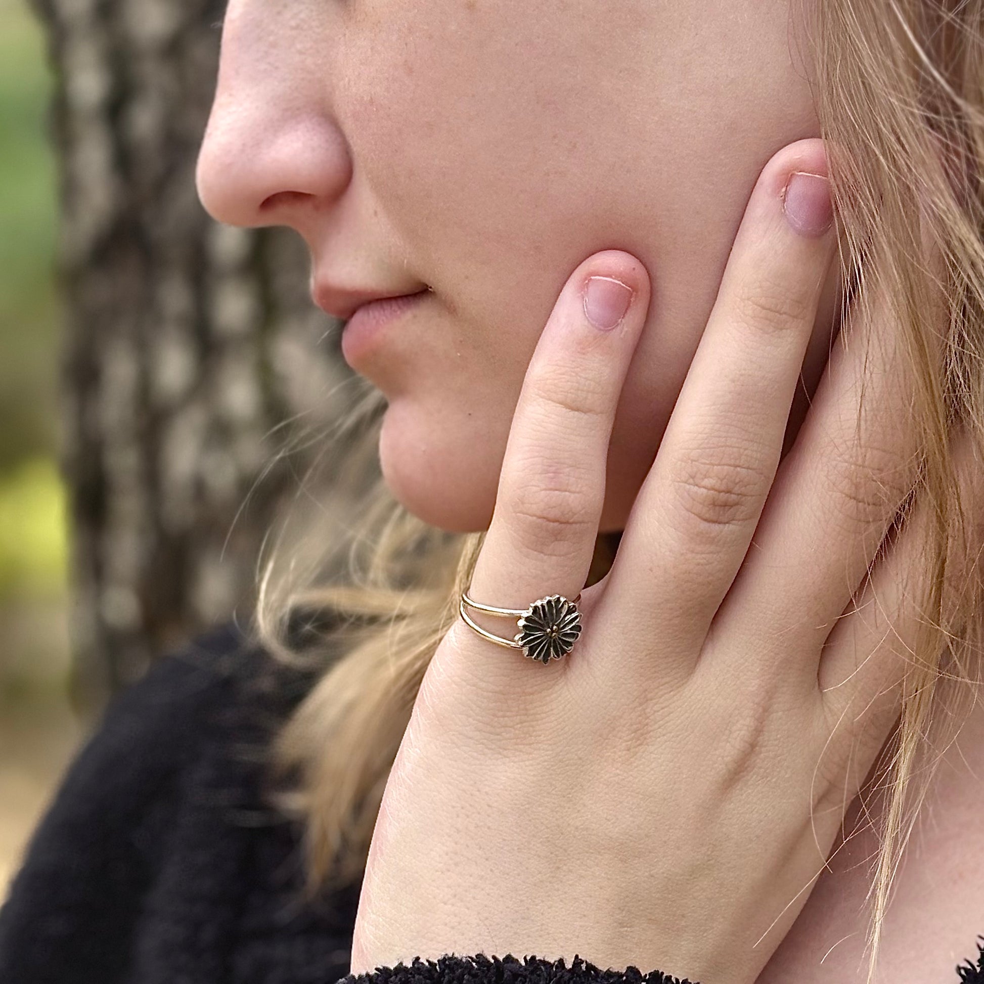 Wild Radiance Ring with Gold Center, a sterling silver handcrafted flower ring, shown on a model